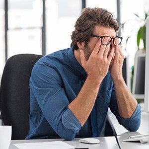 Man at computer screen with irritated eyes