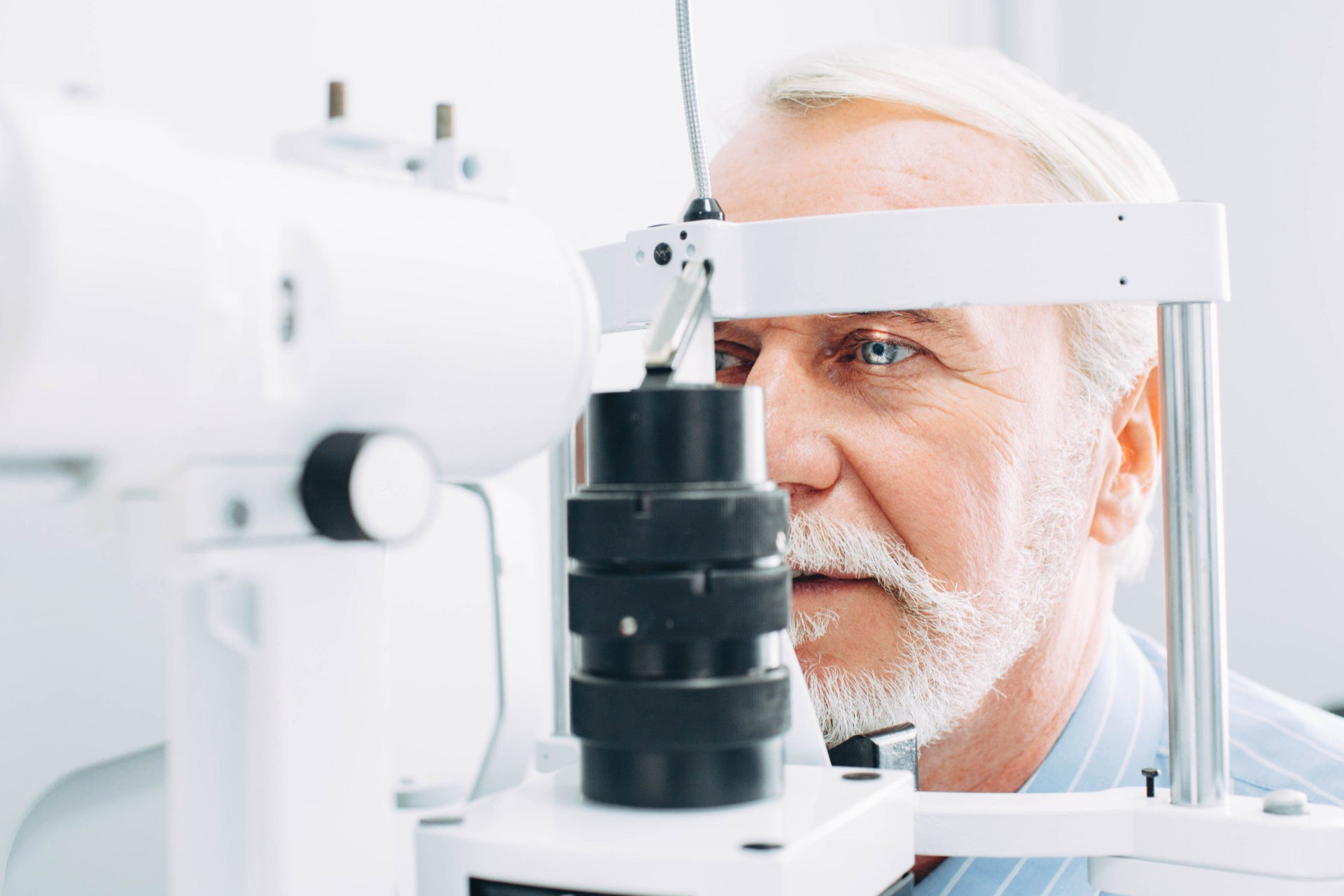 Older man receiving diabetic eye exam at opmt