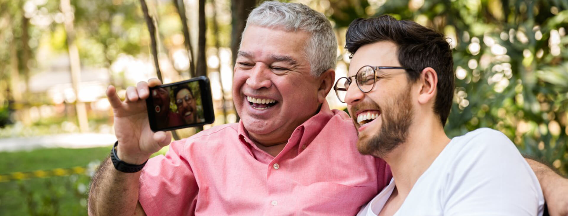 Father and son smiling after receiving eye exams