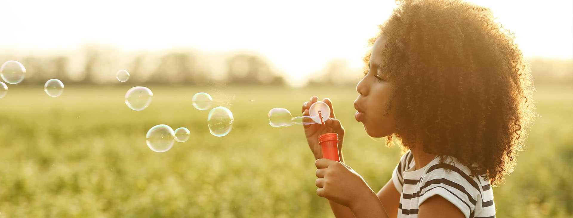 Child blowing balloon at OPMT